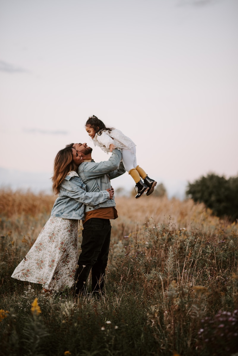 Photo by Hana El Zohiry man and woman kissing on brown grass field during daytime